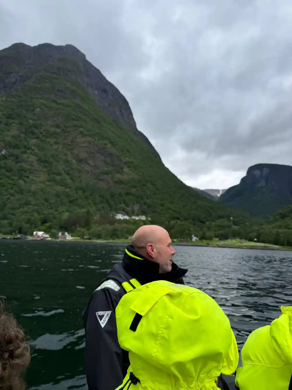 A passenger looking out at the fjord walls from the boat