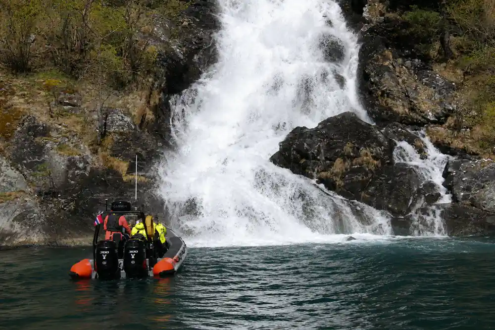 The RIB nosed in close to a waterfall crashing onto rock