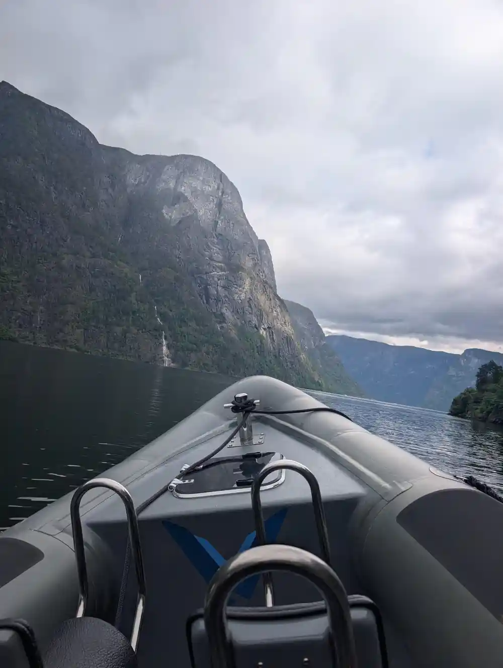 A waterfall on the wall seen past the bow of the boat
