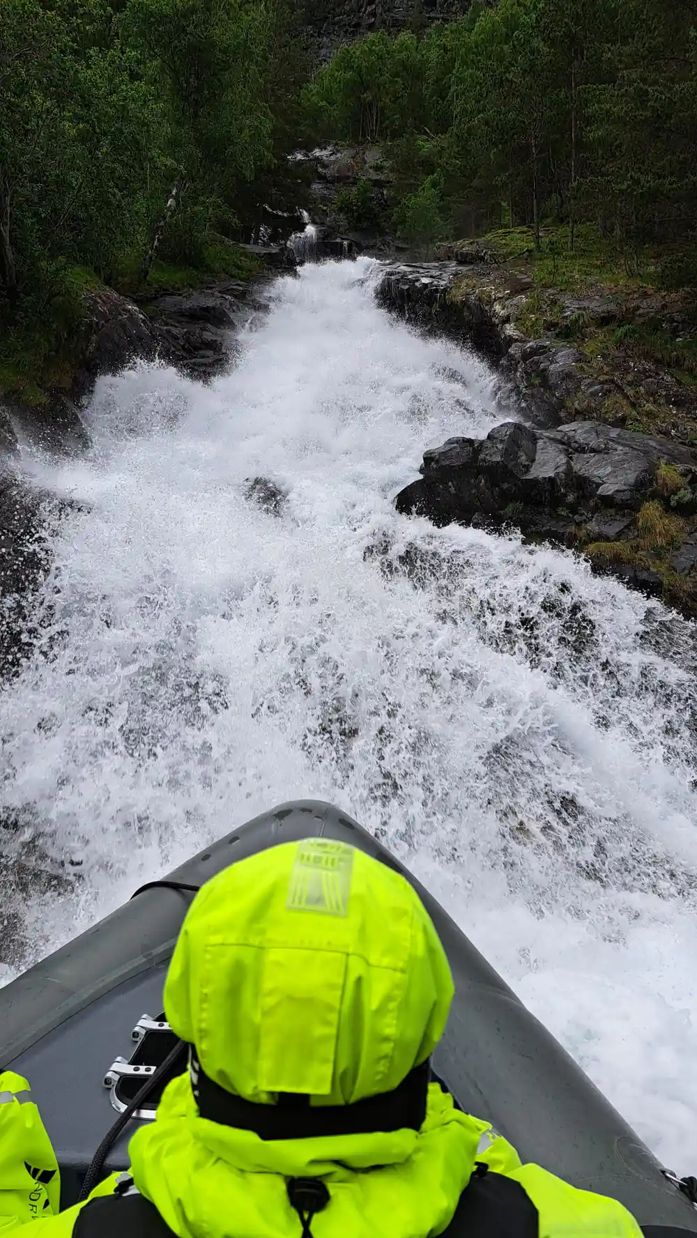 Whitewater breaking over rock right beside the inflatable collar
